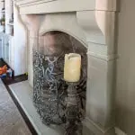 Side view of Bowen cast stone fireplace mantel.