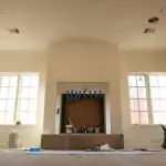 Artistic installation of Old World Stoneworks cast stone fireplace