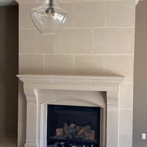 Amhurst cast stone fireplace mantel displayed in a home living room.