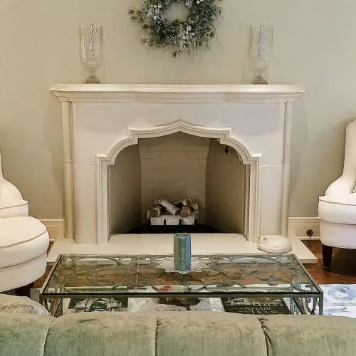 White Avalon cast stone fireplace mantel in a modern home setting.