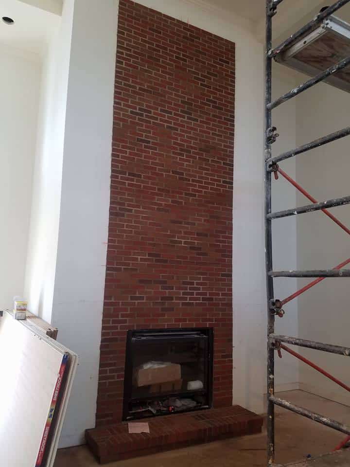 Brunswick cast stone fireplace mantel pre-installation in a customer's living room.