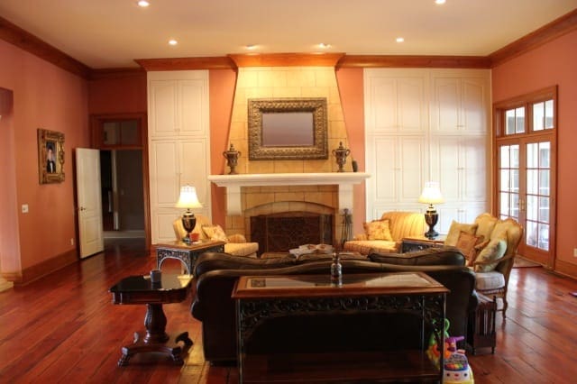 Interior shot featuring a detailed cast stone fireplace mantel.