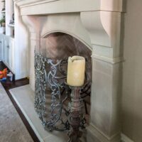 Side view of Bowen cast stone fireplace mantel.