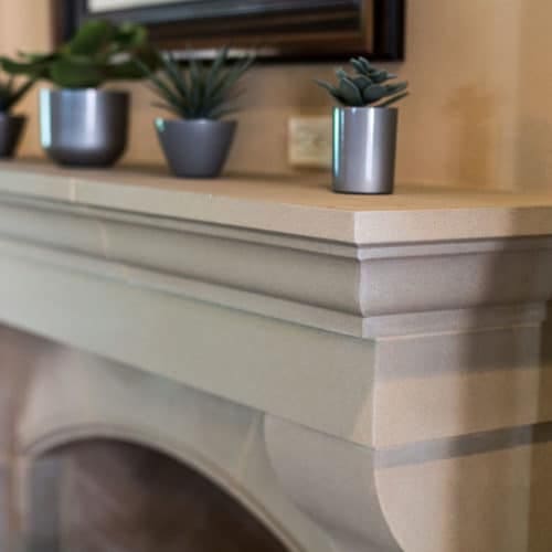 Detailed view of Bowen cast stone fireplace mantel.