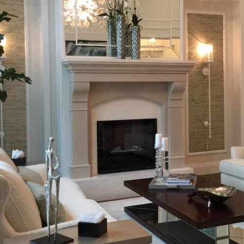Cream-colored Amhurst cast stone fireplace mantel in a customer's living room.