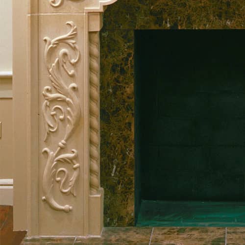 Carved Brentwood cast stone fireplace mantel leg detail.