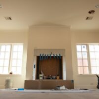 Artistic installation of Old World Stoneworks cast stone fireplace