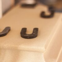 Intricate cast stone fireplace mantel installation in luxury home