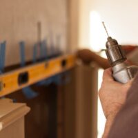 Installers installing fireplace mantel by Old World Stoneworks