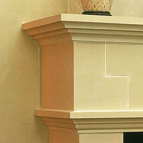 Tuscan cast stone fireplace mantel left upper corner detail.